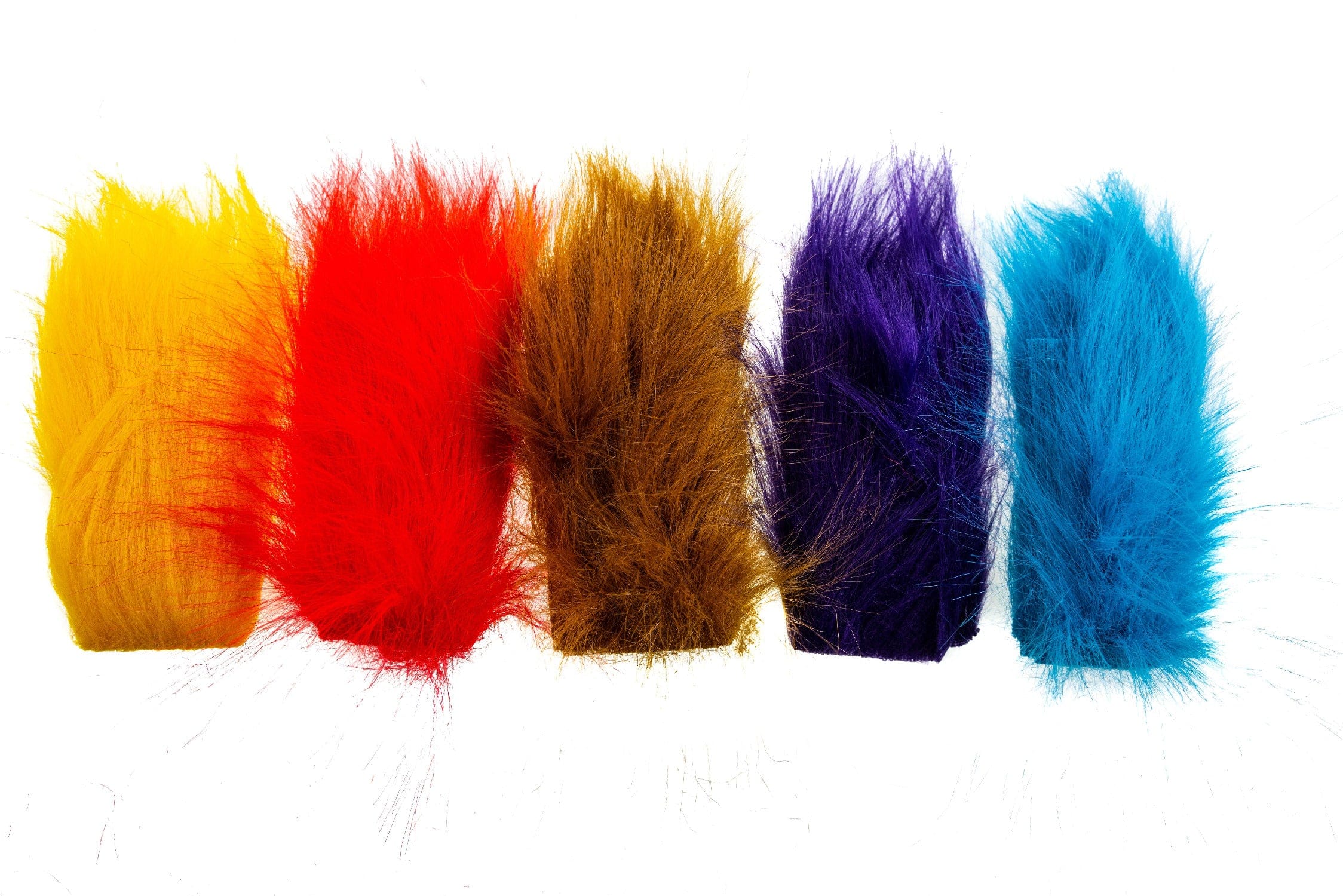 Five fluffy Hareline craft fur strips in yellow, red, brown, purple and teal for fly tying