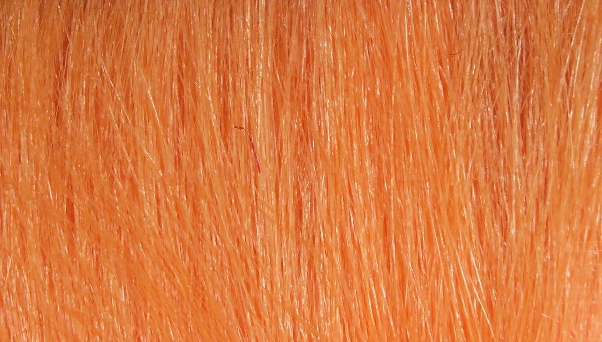 Bright orange Hareline Extra Select craft fur with dense, straight glossy fibers for fly tying and lure crafting