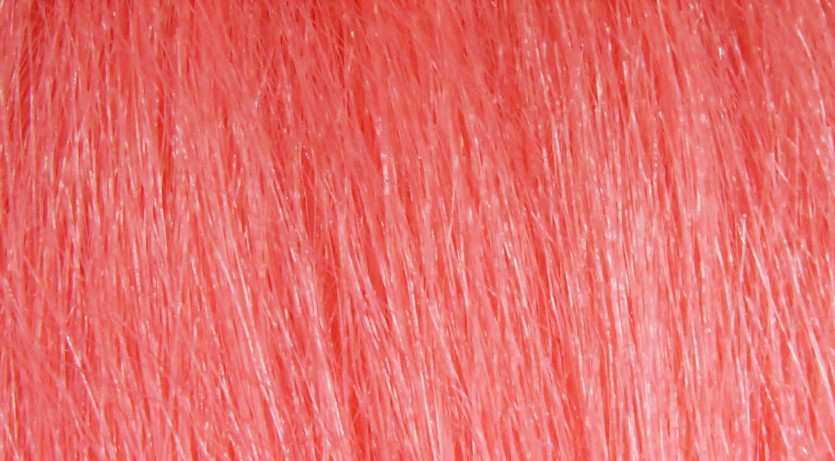 Coral pink Hareline Extra Select craft fur with fine glossy synthetic fibers for fly tying and lures
