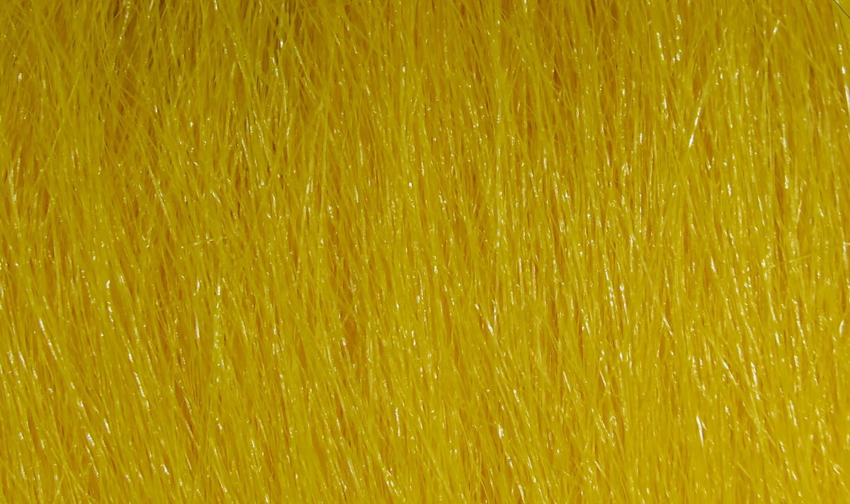 Bright yellow Hareline Extra Select craft fur close-up showing fine glossy synthetic fibers for fly tying