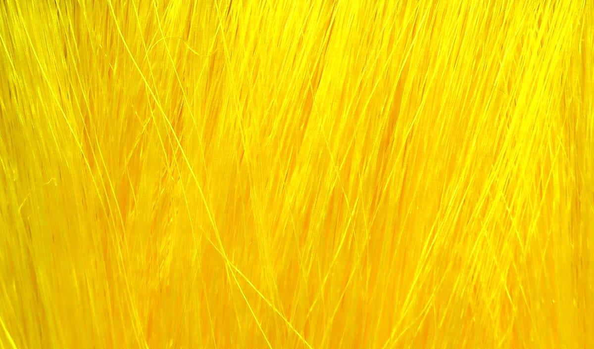 Bright yellow Hareline Fishair synthetic fly tying fibers, long glossy thin strands for streamers and lures