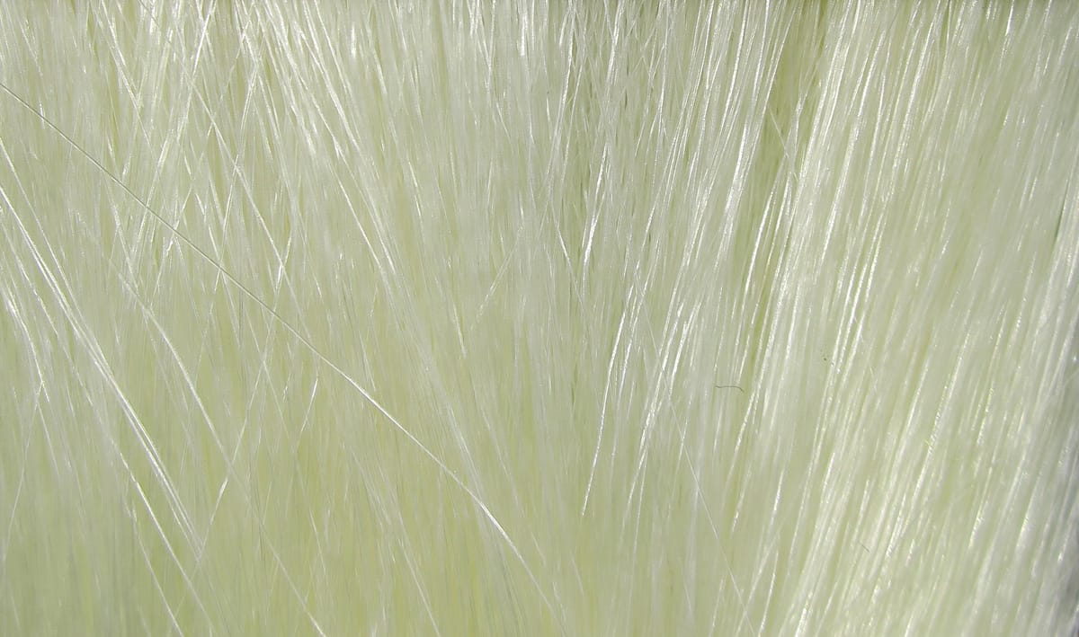 Pale chartreuse Hareline Fishair synthetic fly tying fibers, glossy translucent long strands for streamers