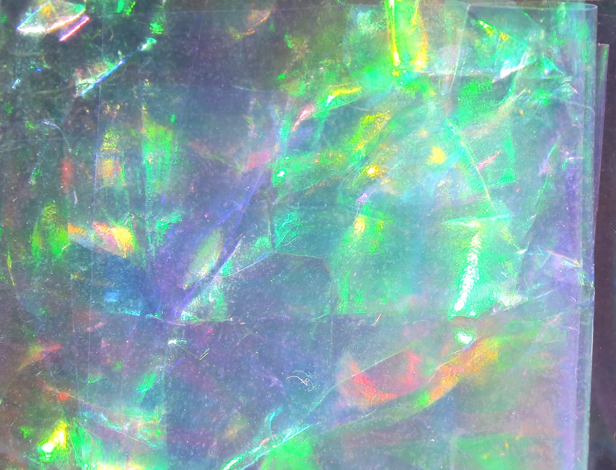 Hareline Flashback translucent holographic sheet with green, purple and gold iridescent shimmer for fly tying