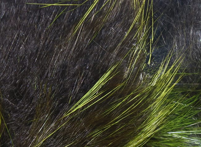 Dark brown rabbit fur strips with bright chartreuse frosted tips, glossy long guard hairs for fly tying.
