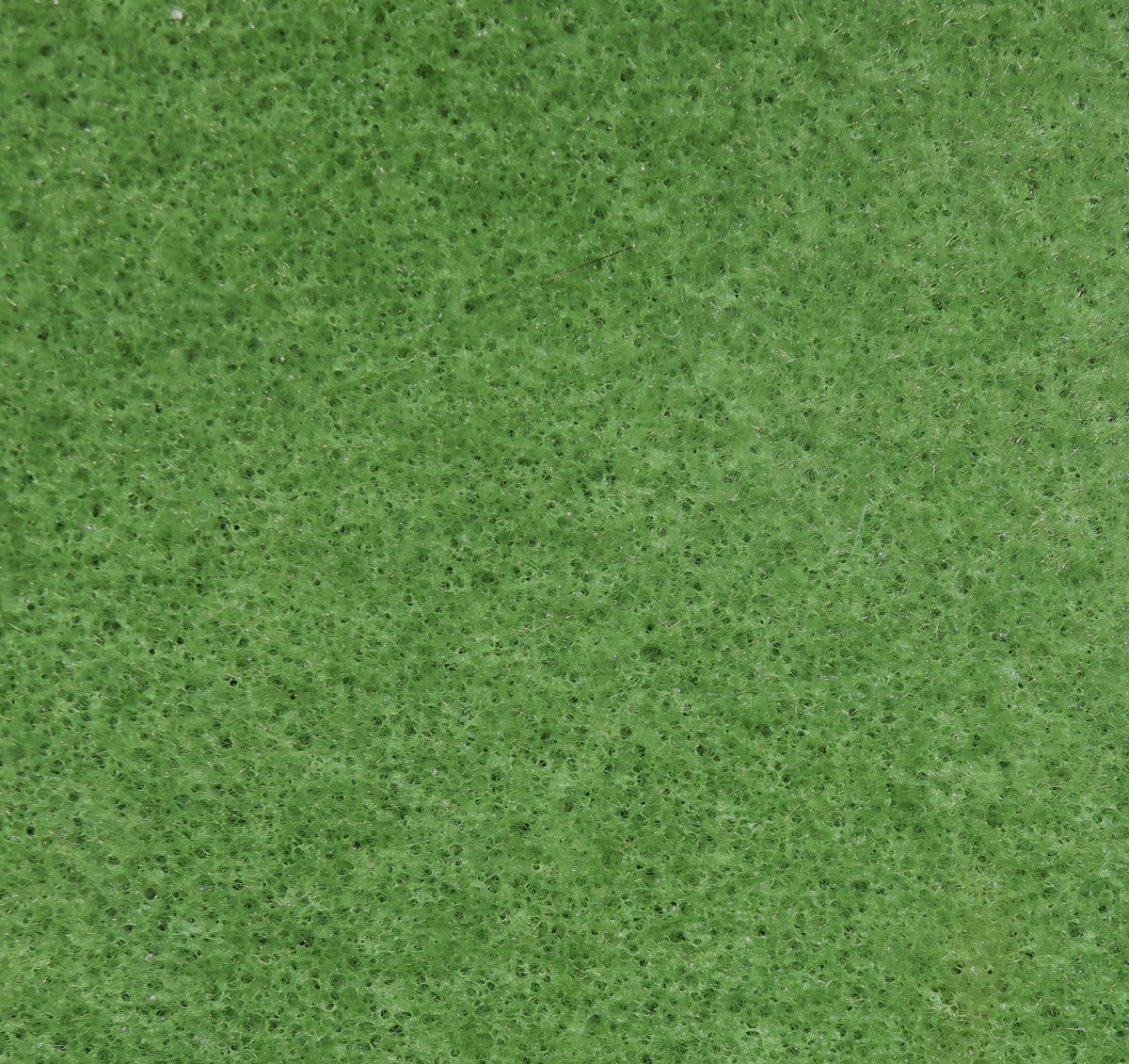 Bright green Hareline furry foam sheet with porous spongy texture and fine hair-like nap, fly tying foam