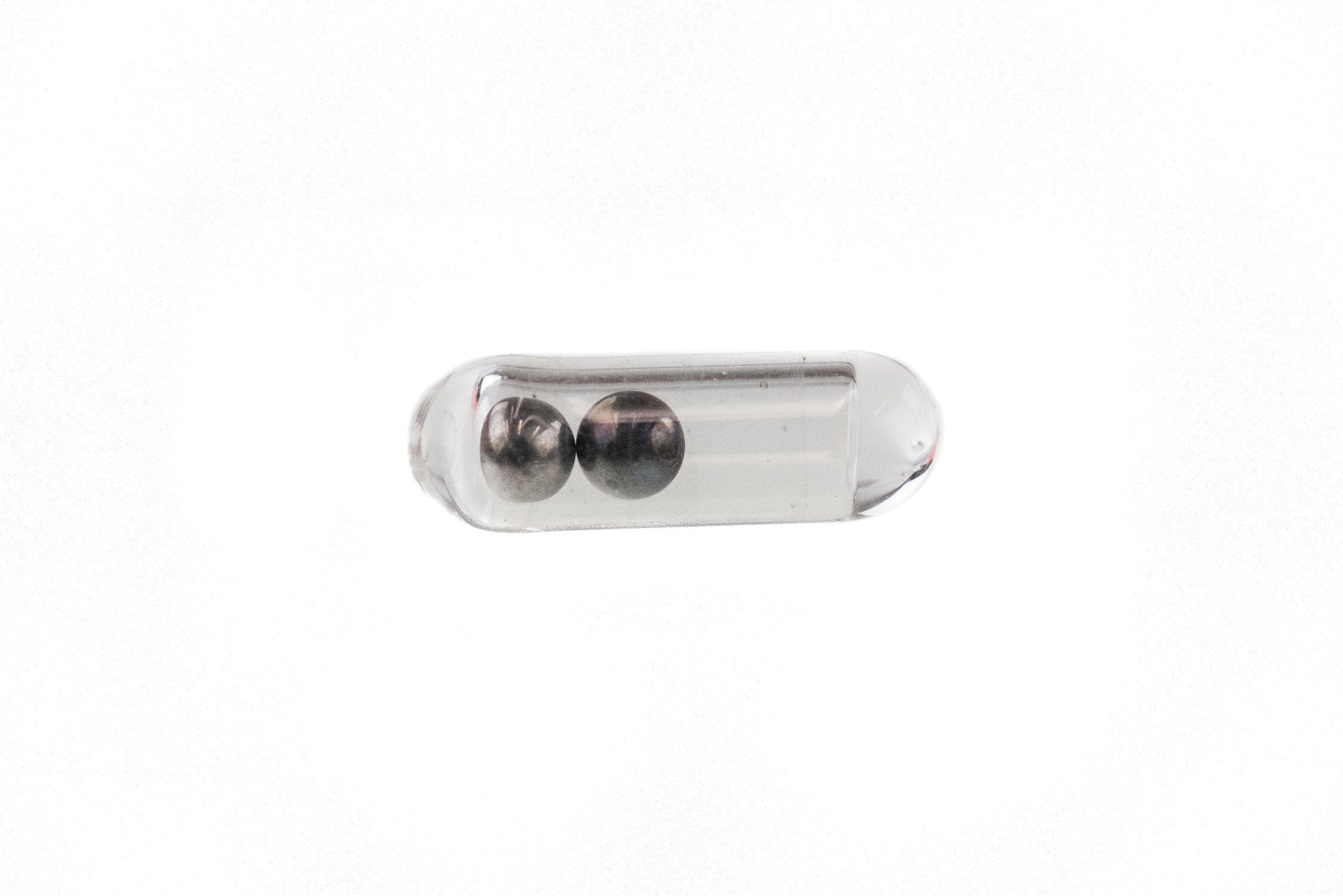 Clear tubular glass capsule holding two metallic silver beads, Hareline glass rattlers for fly tying