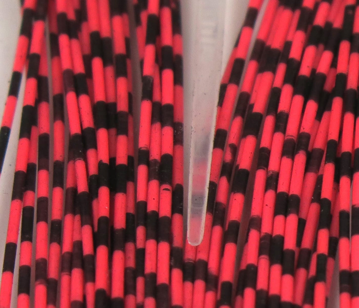 Hareline grizzly neon pink and black barred rubber legs for fly tying, close-up of striped flexible rubber strands