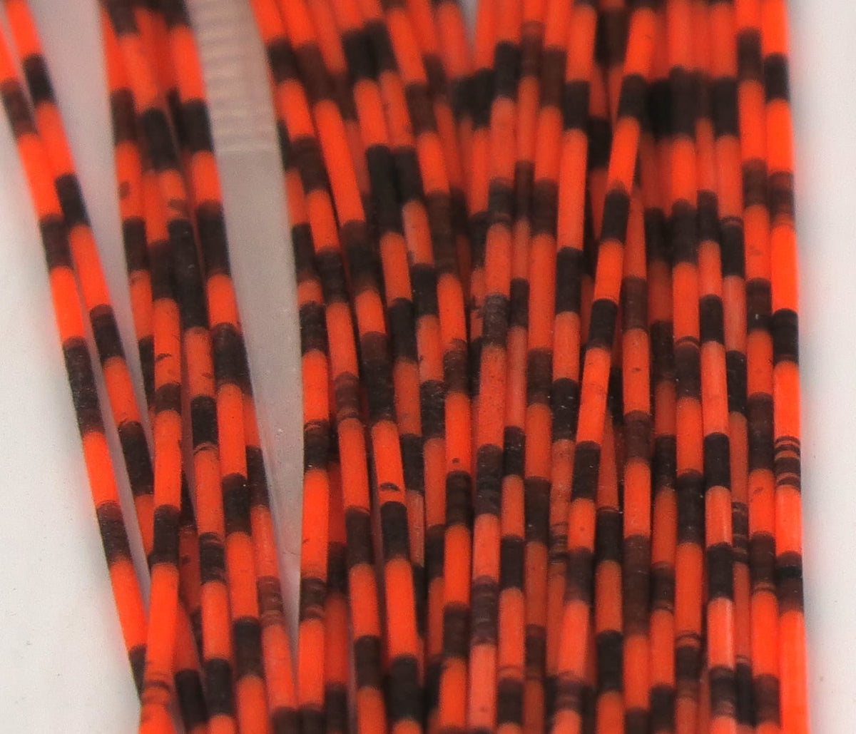 Hareline grizzly barred rubber legs bright orange and black barred rubber strands for fly tying