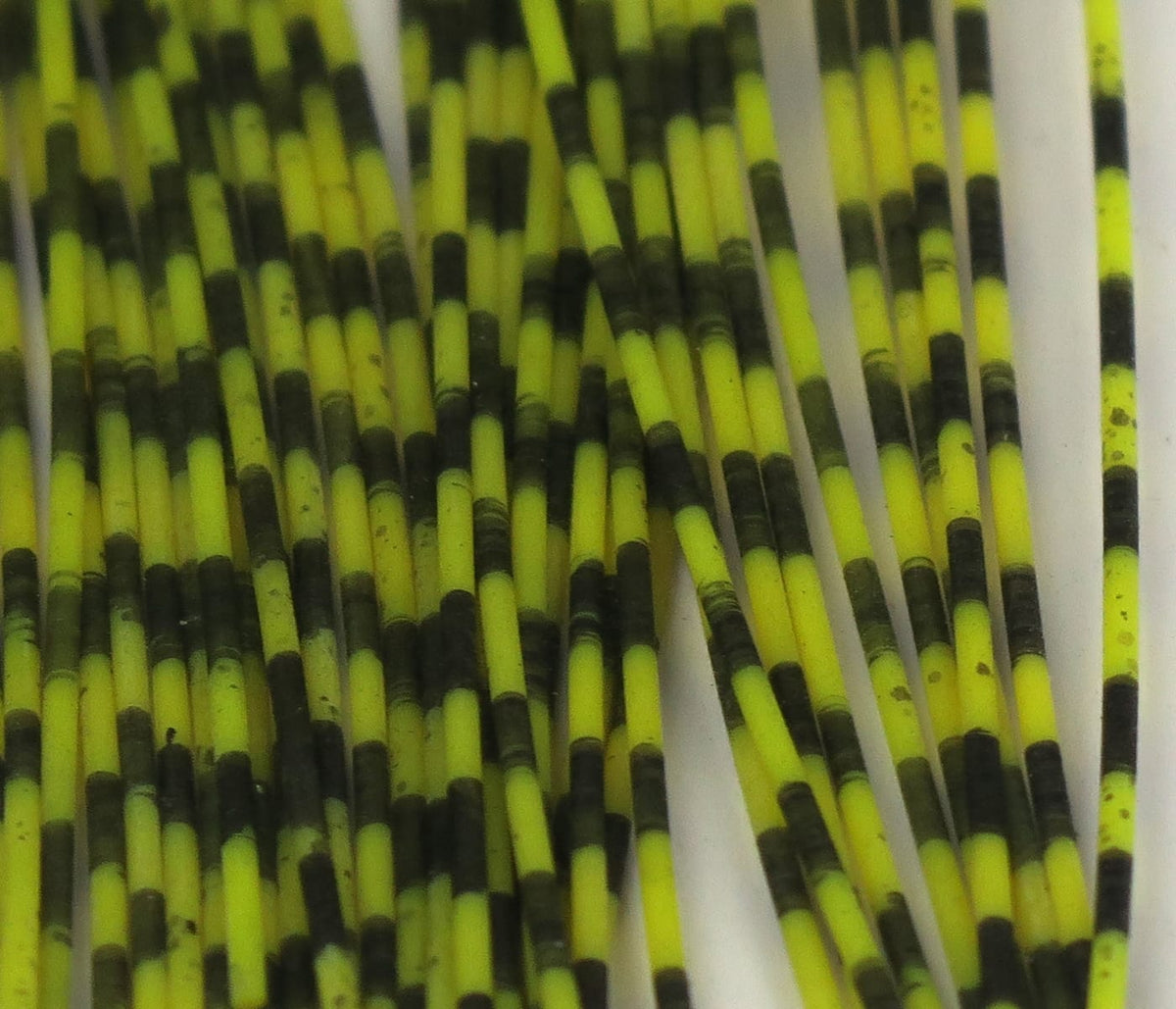 Grizzly barred rubber legs in neon yellow and black, flexible segmented rubber strands for fly tying