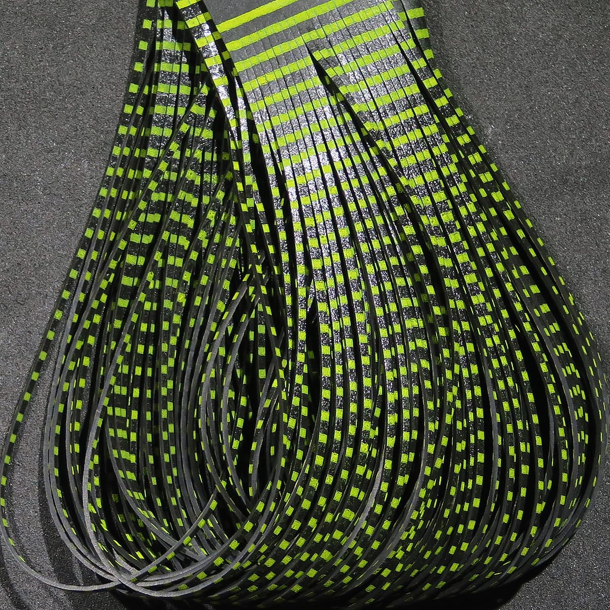 Hareline Grizzly Flutter Legs glossy black rubber strands with chartreuse grizzly checkered stripes for fly tying