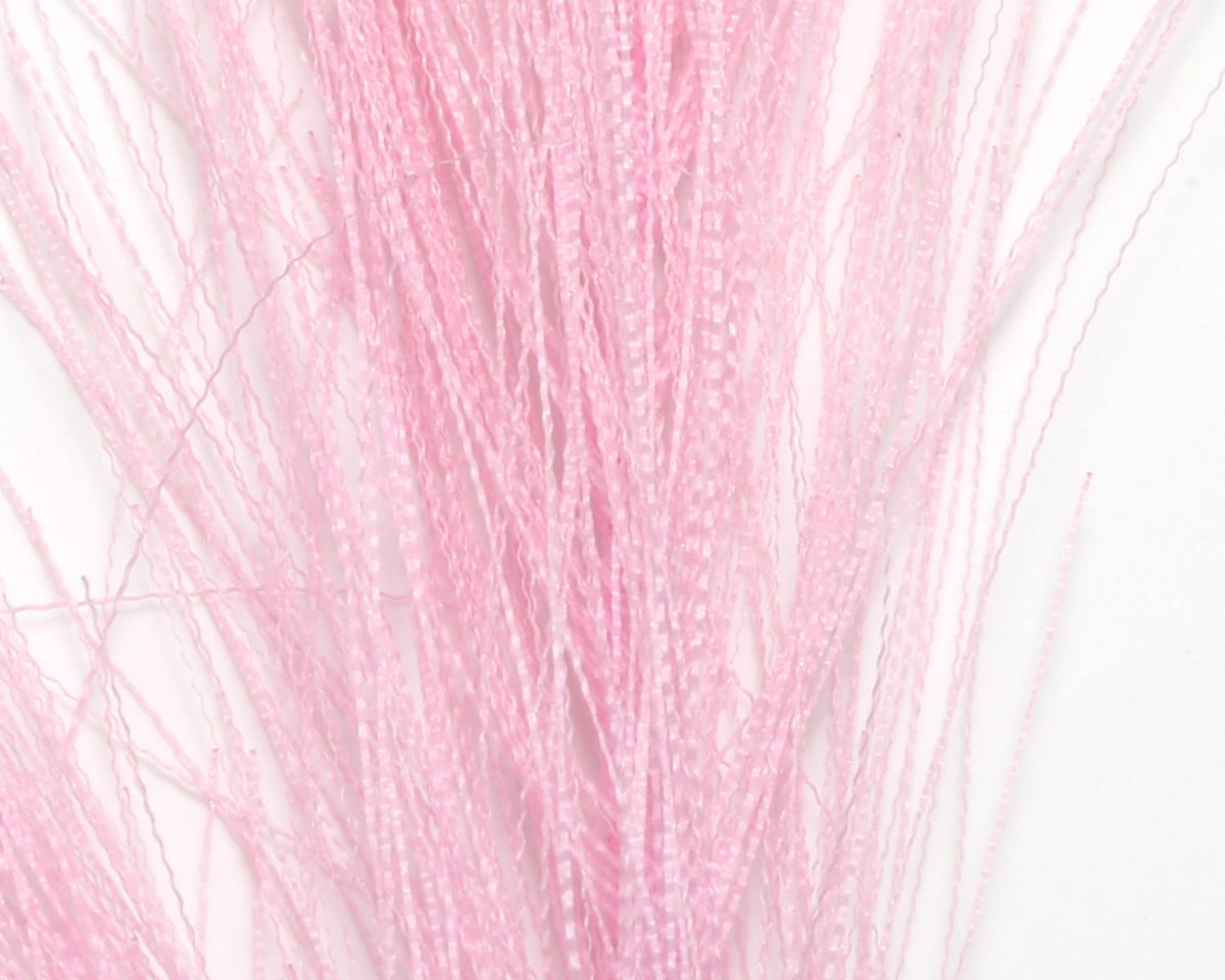 Pale pink synthetic hackle hair strands with glossy crimped texture, long thin fibers for fly tying