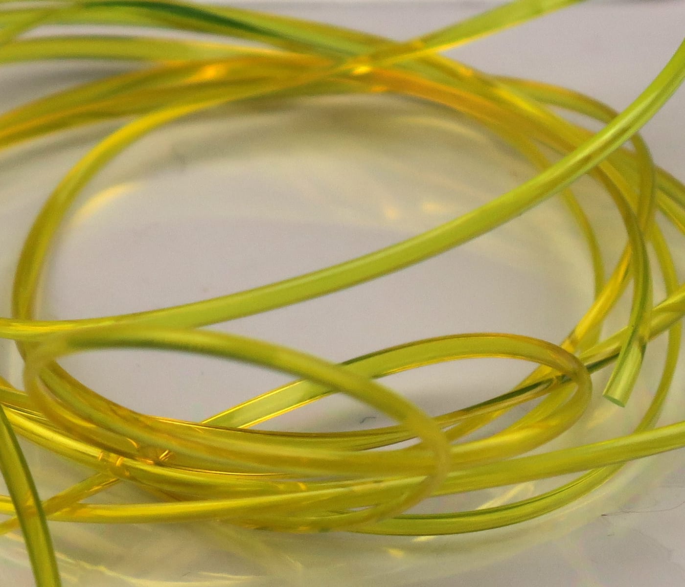 Chartreuse translucent half-round D-rib coil, smooth plastic fly tying rib material