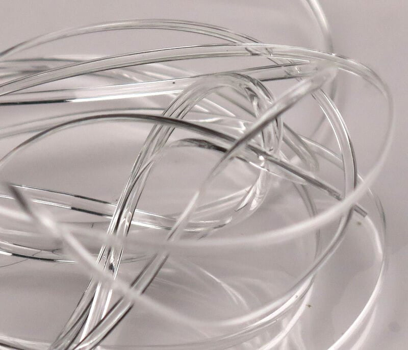 Clear Hareline half-round D-rib coiled translucent plastic fly tying ribbing with glossy D-shaped strands