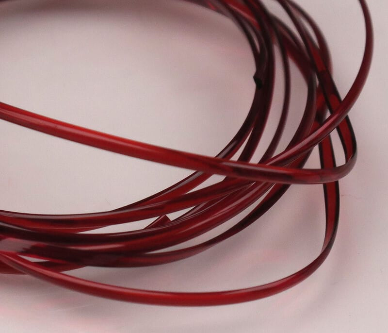 Translucent deep red plastic half-round D-rib coil, glossy thin ribbing for fly tying