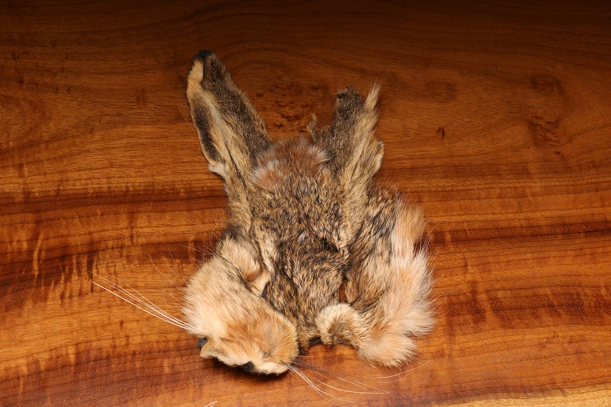 Natural brown hare mask with mottled fur, long whiskers and upright ears for fly tying