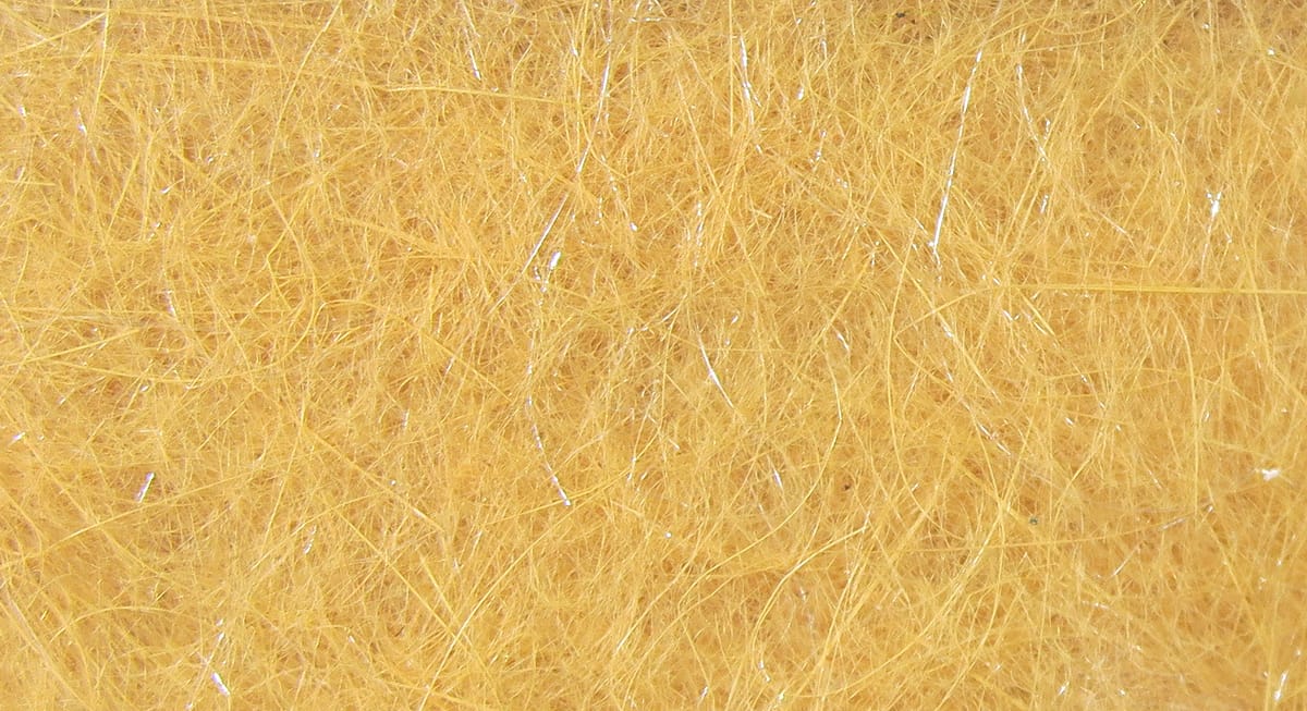 Hareline Hare-Tron dubbing in golden tan, fine synthetic fibrous material with subtle iridescent strands for fly tying.