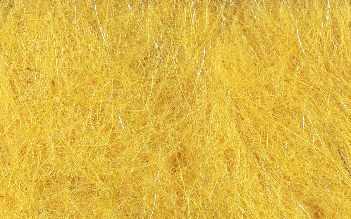 Bright golden-yellow Hare-Tron fly tying dubbing with fine synthetic fibers and silver tinsel flash