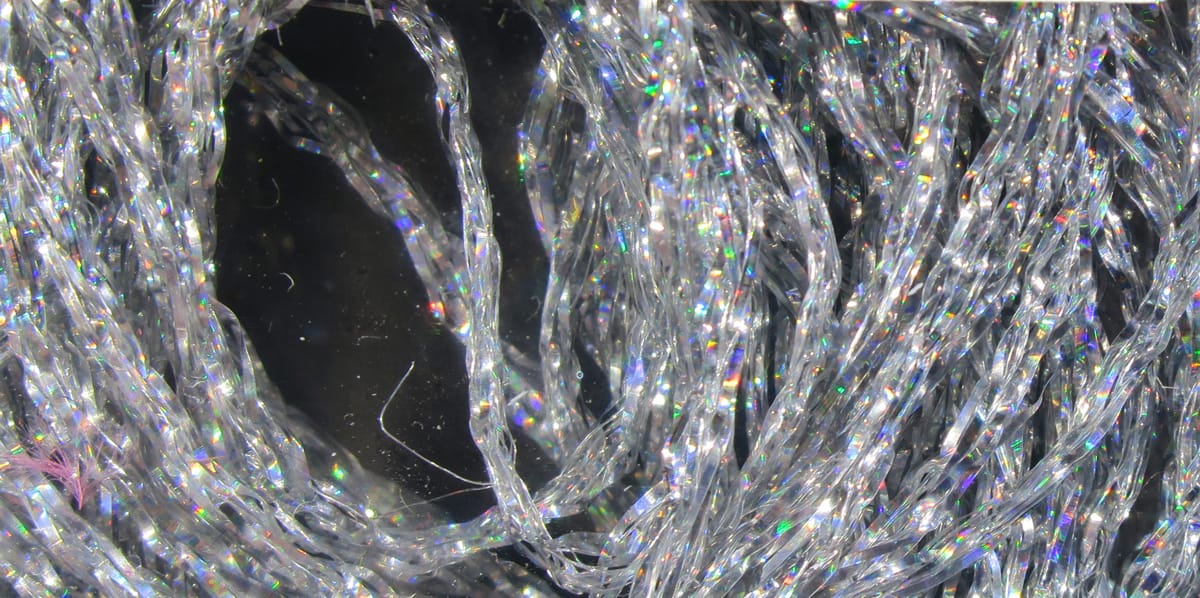 Hareline holographic braid: clear twisted synthetic strands with iridescent rainbow sparkle for fly tying
