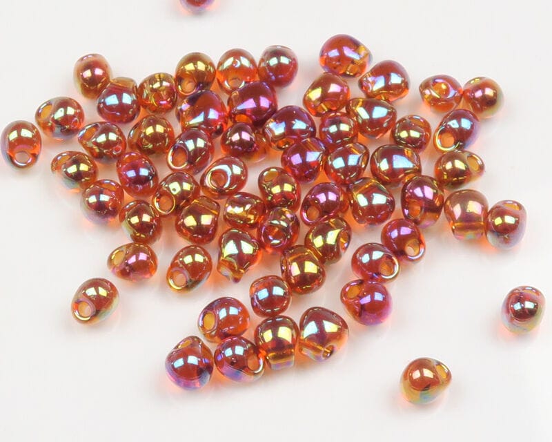 Hareline hump back iridescent amber-orange glass beads with teardrop shape and large holes for fly tying