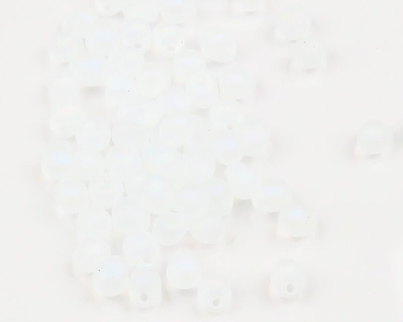 Hareline hump-back translucent matte white glass beads with center holes scattered on white background
