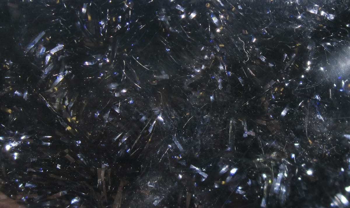 Black ice chenille with fine silver iridescent tinsel strands, sparkly synthetic fly-tying material