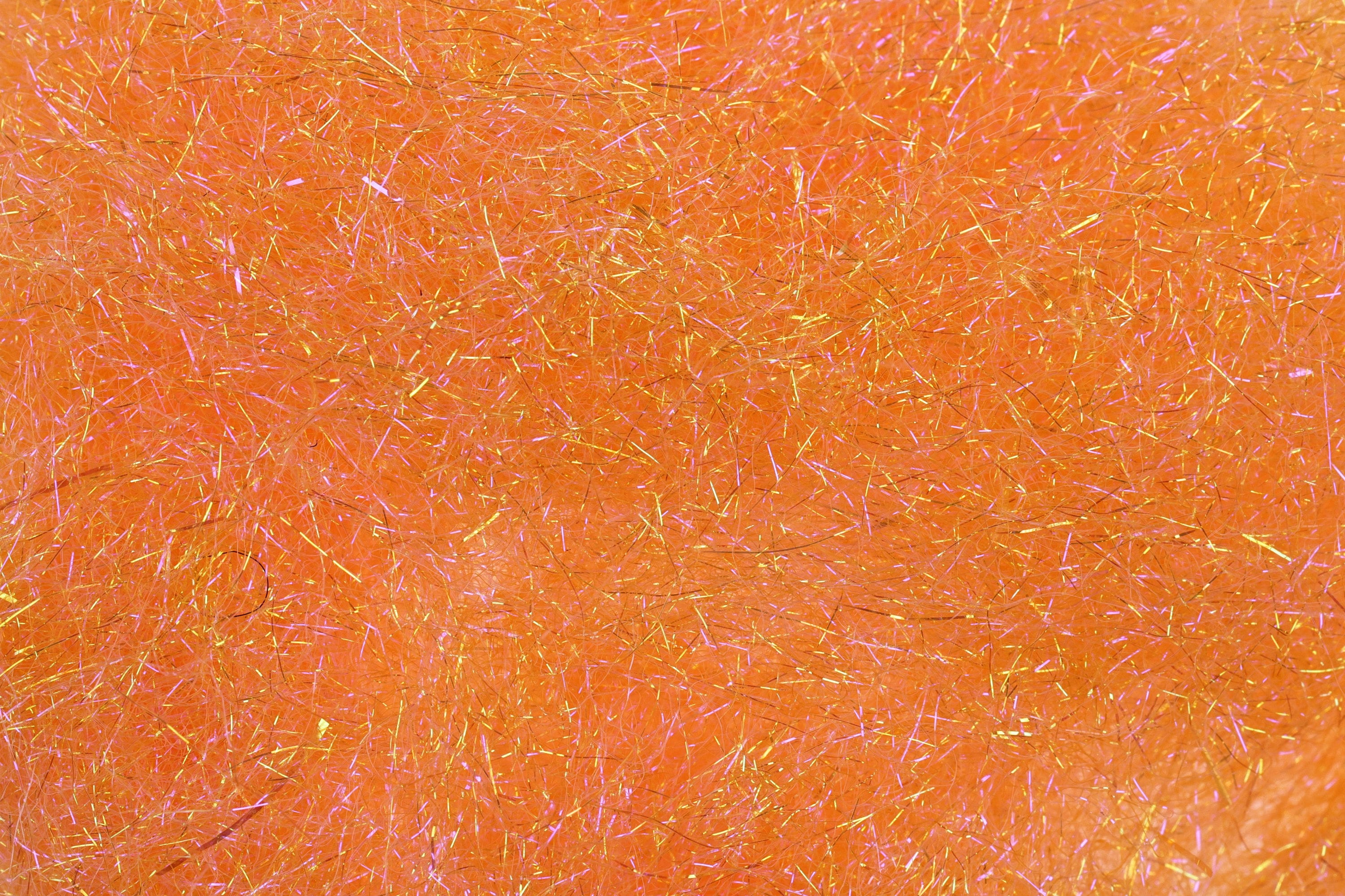 Bright orange Hareline ice dubbing with iridescent gold and pink sparkle fibers for fly tying