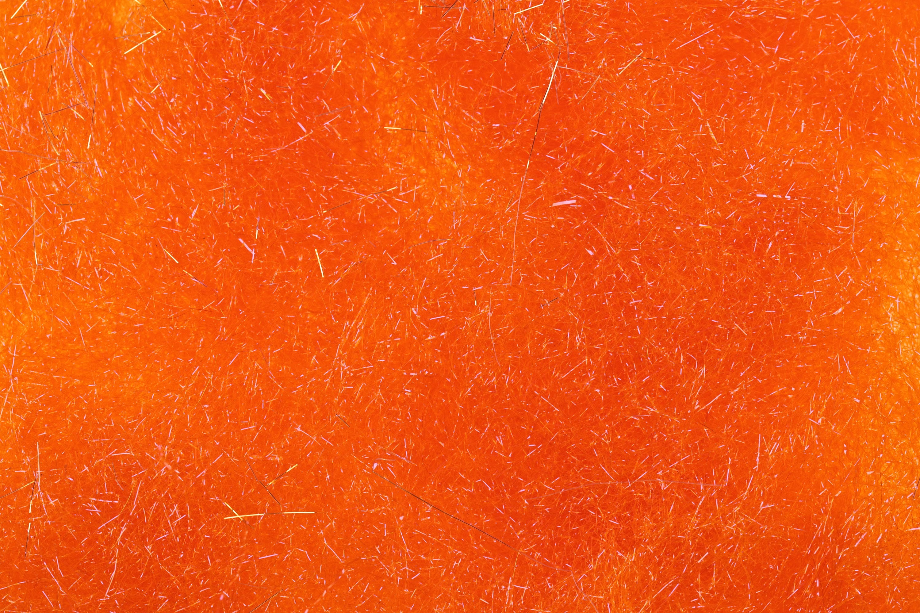 Bright fluorescent orange Hareline Ice Dubbing with fine synthetic fibers and iridescent flash strands for fly tying