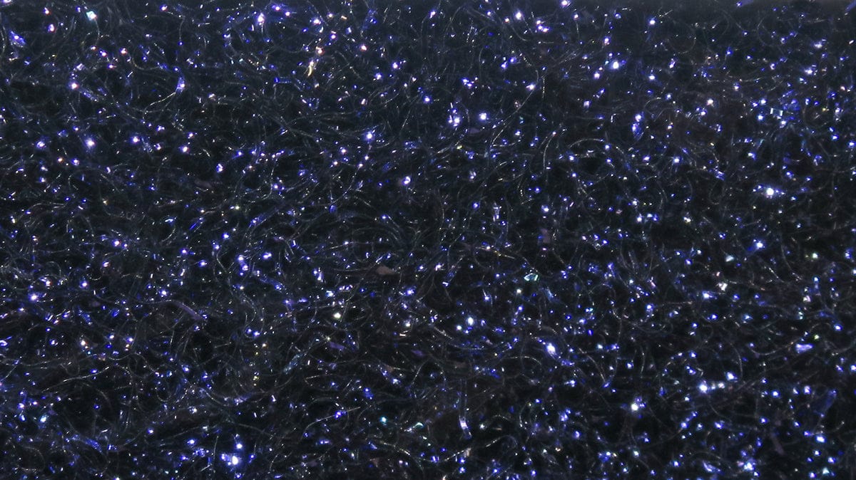 Hareline Ice Dubbing black synthetic fibers with blue iridescent sparkle for fly tying