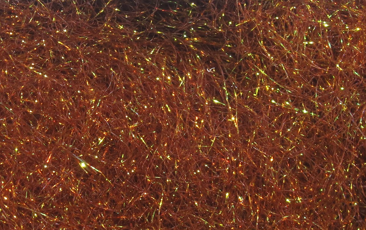 Copper brown Hareline Ice Dubbing fibers with iridescent gold-green flash, synthetic dubbing for fly tying