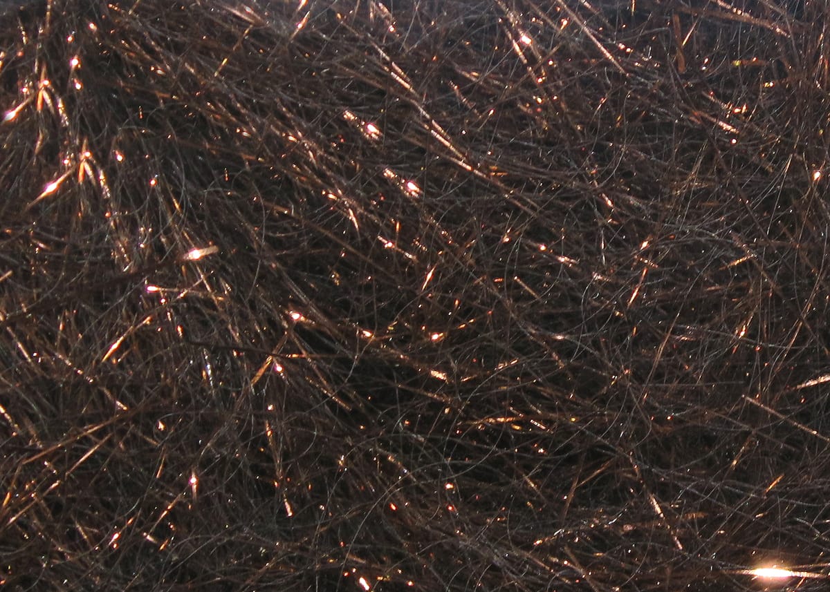Dark brown Hareline Ice Dubbing with fine synthetic fibers and coppery flash for fly tying