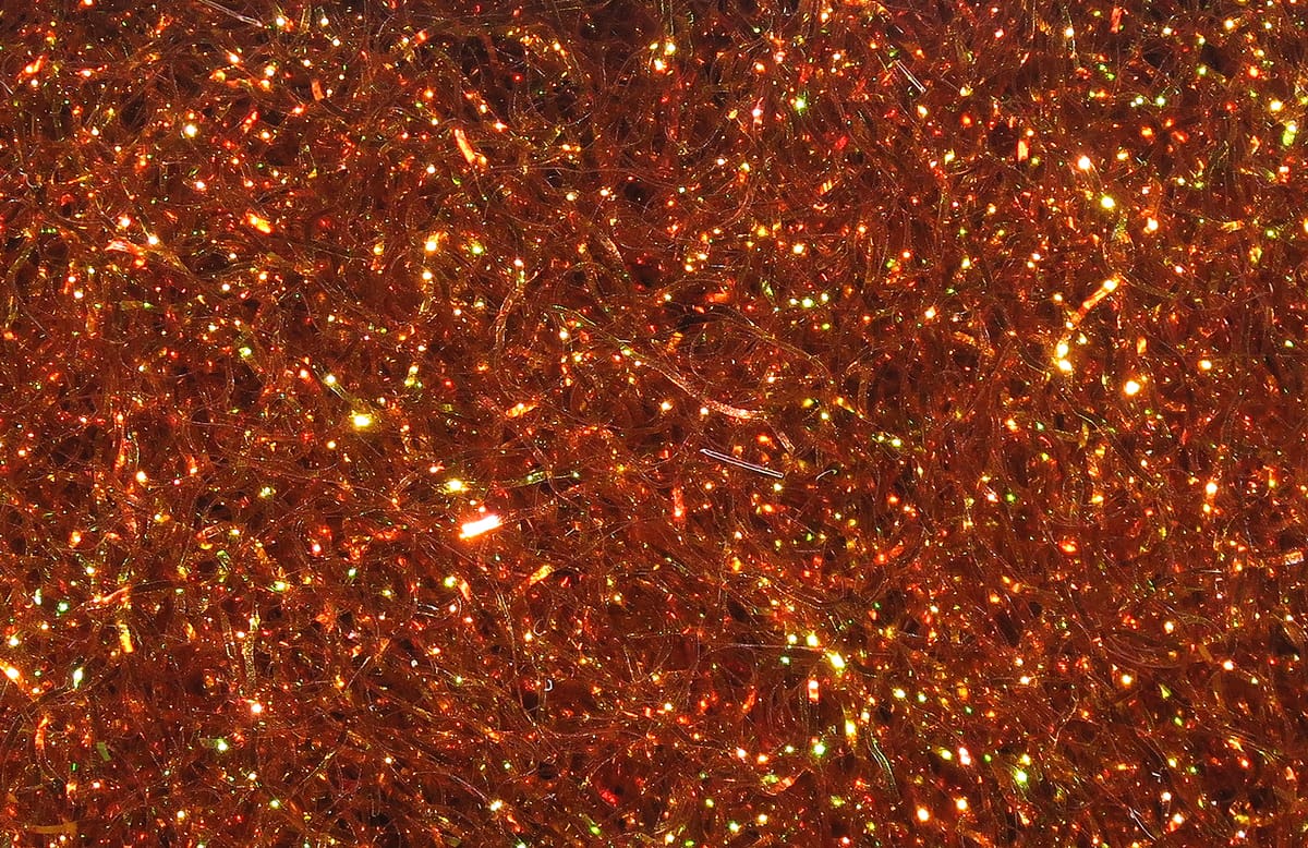 Copper orange Hareline Ice Dubbing synthetic fibers with iridescent flash for fly tying, fine glittery strands