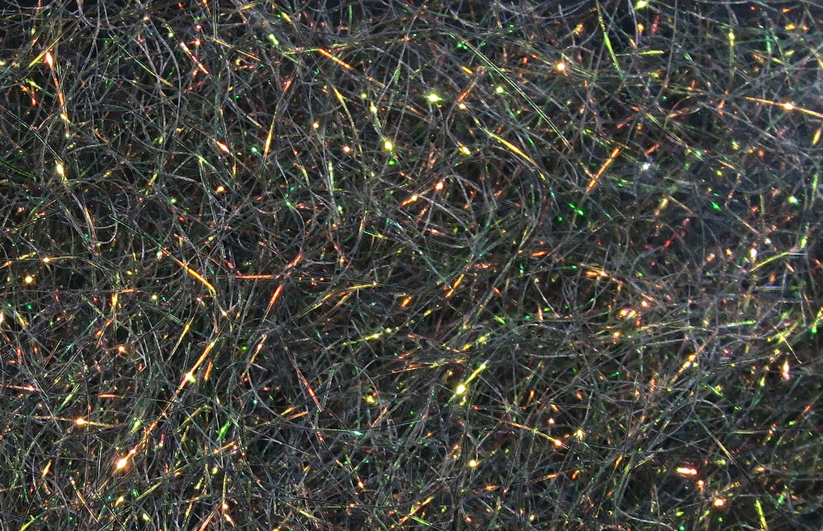 Black Hareline Ice Dubbing fine fibers with iridescent tinsel sparkle, fly-tying dubbing with green-gold highlights