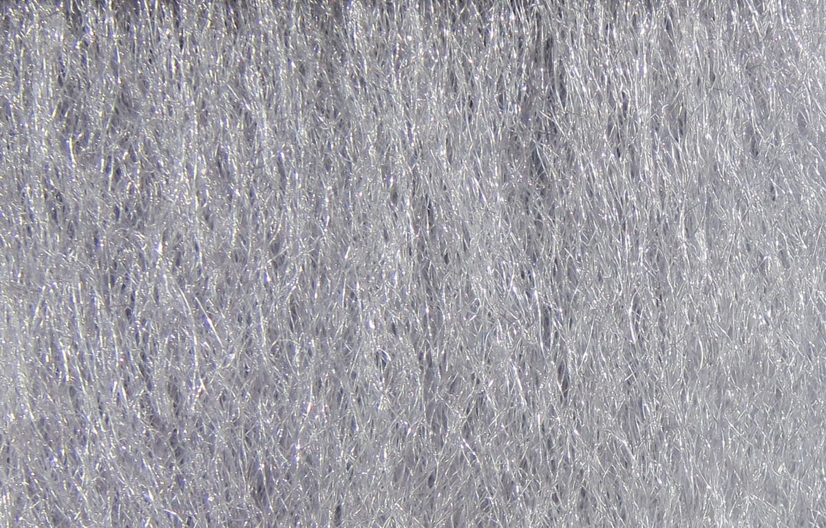 Silver-gray Hareline Ice Fur synthetic fibers with fine iridescent strands and sparkling tinsel for fly tying