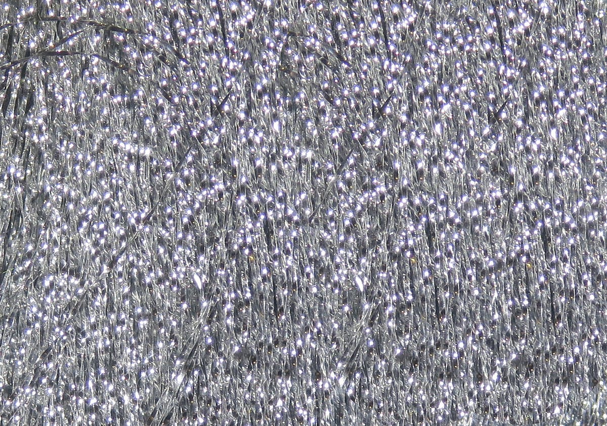 Silver Hareline Krystal Flash: densely packed sparkling synthetic fly tying fibers with fine iridescent strands