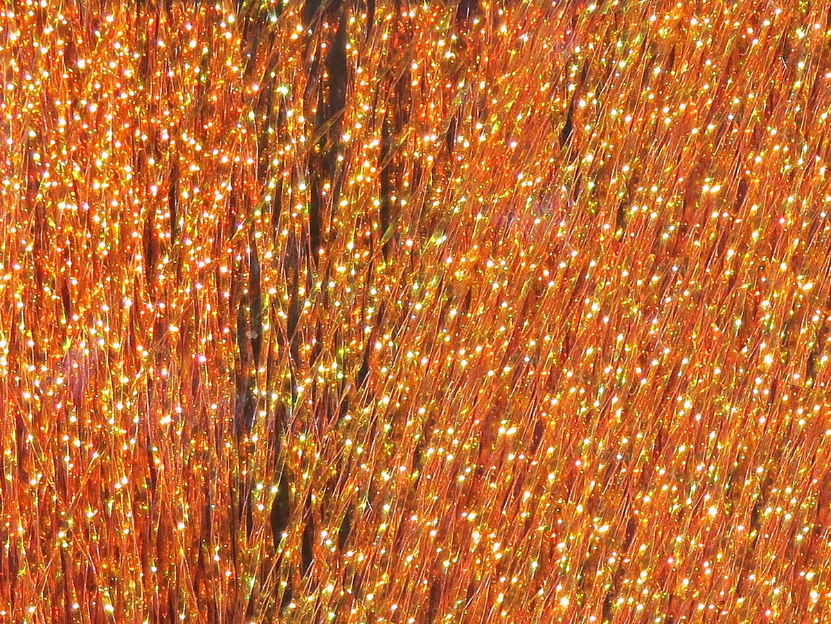 Hareline Krystal Flash orange metallic flash fibers, fine iridescent strands with gold-green sparkle for fly tying