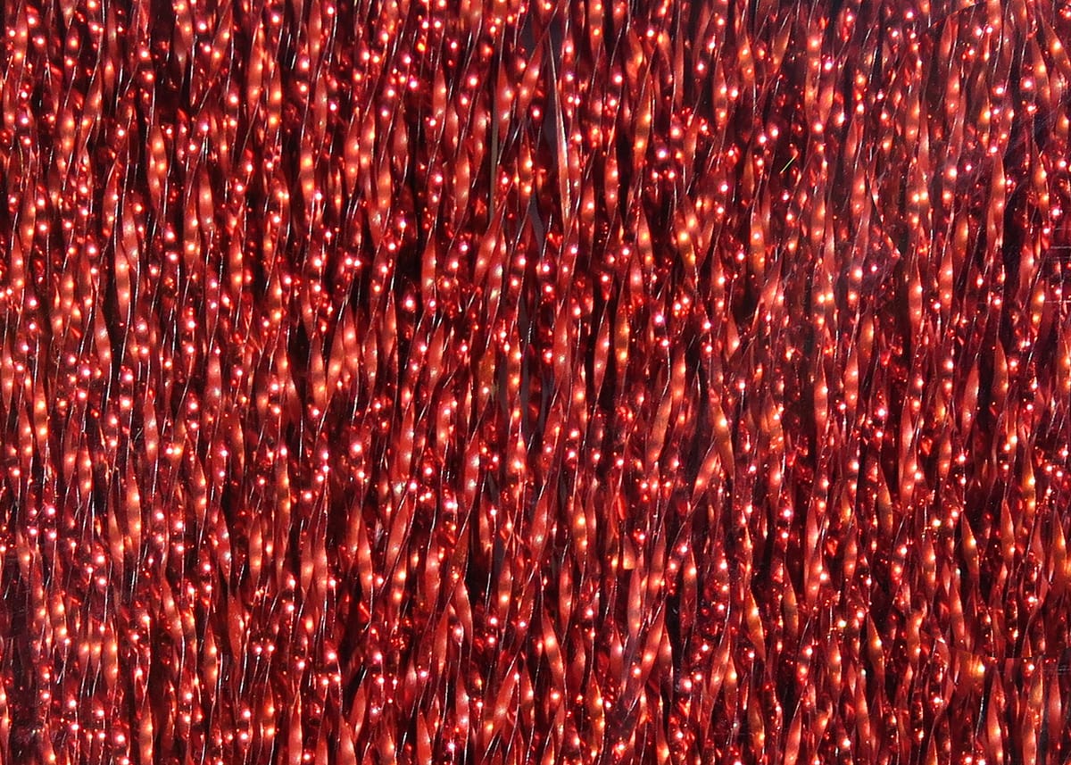Red Krystal Flash metallic strands with sparkling twisted synthetic fibers for fly tying