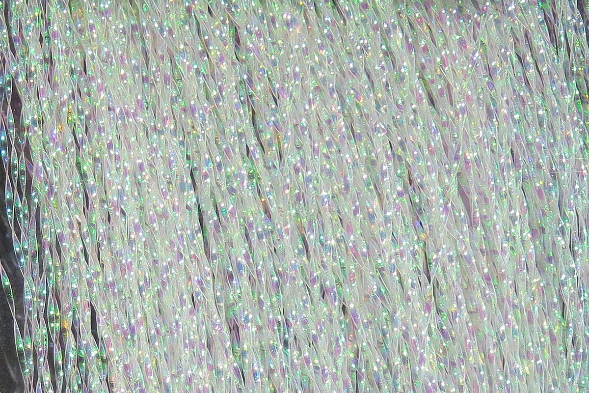 Iridescent white Hareline Krystal Flash strands with holographic green and purple sparkle, synthetic fly tying material