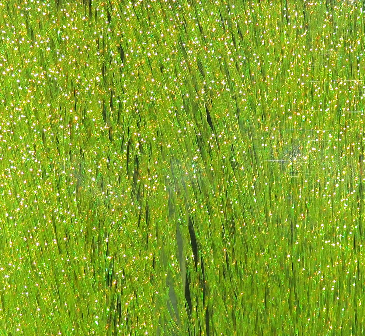 Shimmering lime-green Krystal Flash strands with iridescent gold flakes, synthetic tinsel fly tying material for lures