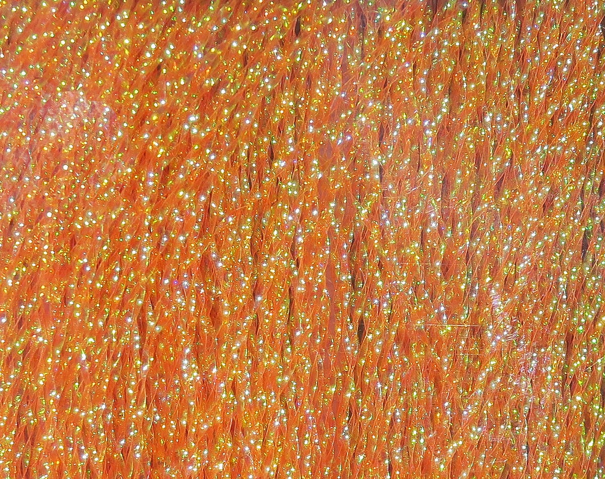 Hareline Krystal Flash orange synthetic fibers with iridescent gold-green sparkle, thin flashy strands for fly tying