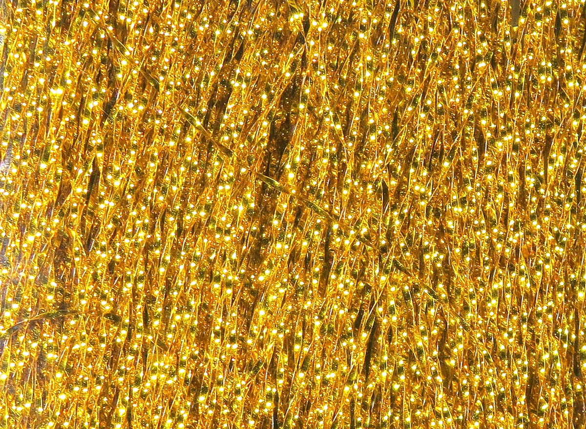 Gold Krystal Flash strands by Hareline, shimmering metallic tinsel fibers for fly tying