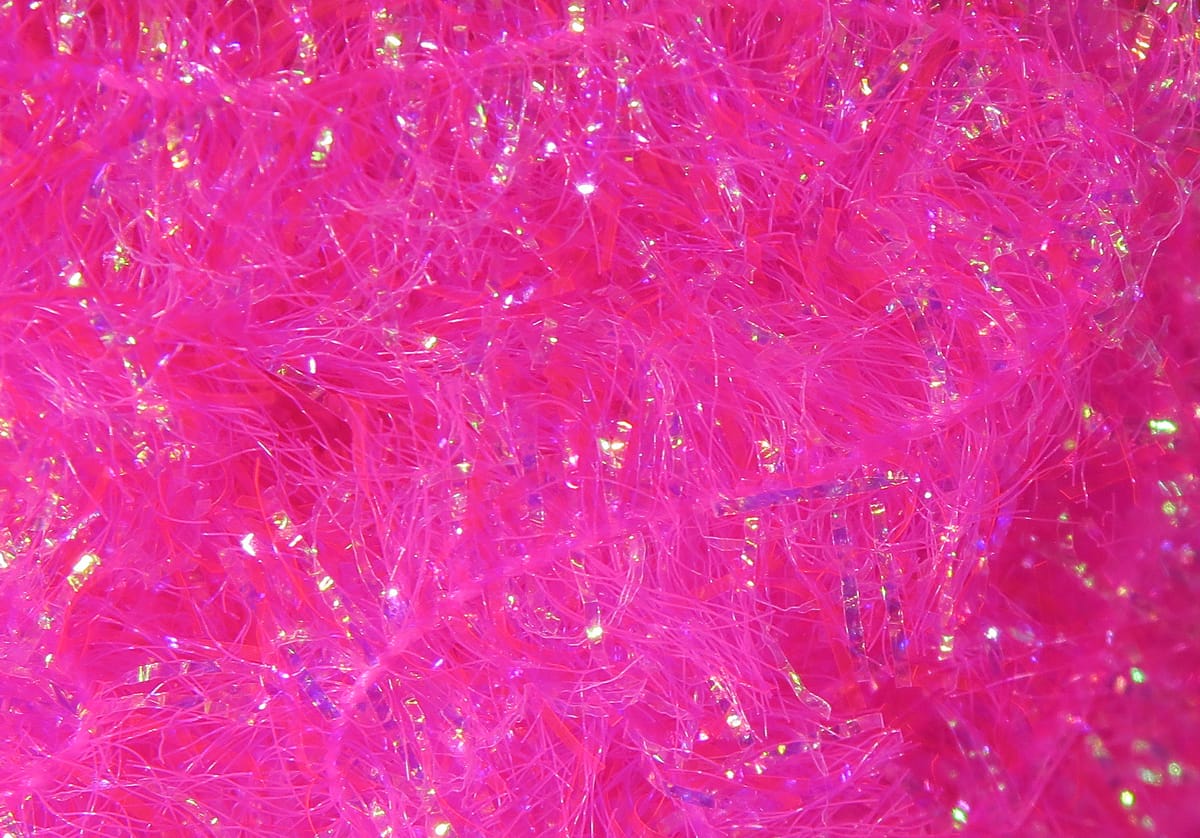 Neon hot pink Hareline Krystal Flash chenille fibers with iridescent strands, fuzzy sparkly fly tying material