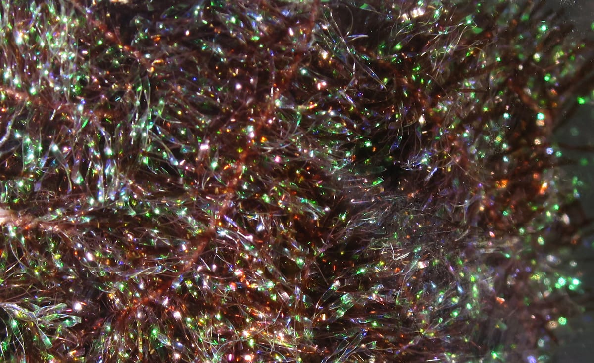 Hareline Krystal Flash chenille copper-brown with iridescent green and purple sparkling synthetic fibers for fly tying