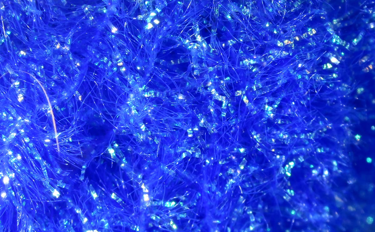 Hareline Krystal Flash Chenille in bright blue, iridescent shredded fibers and sparkling flash material for fly tying