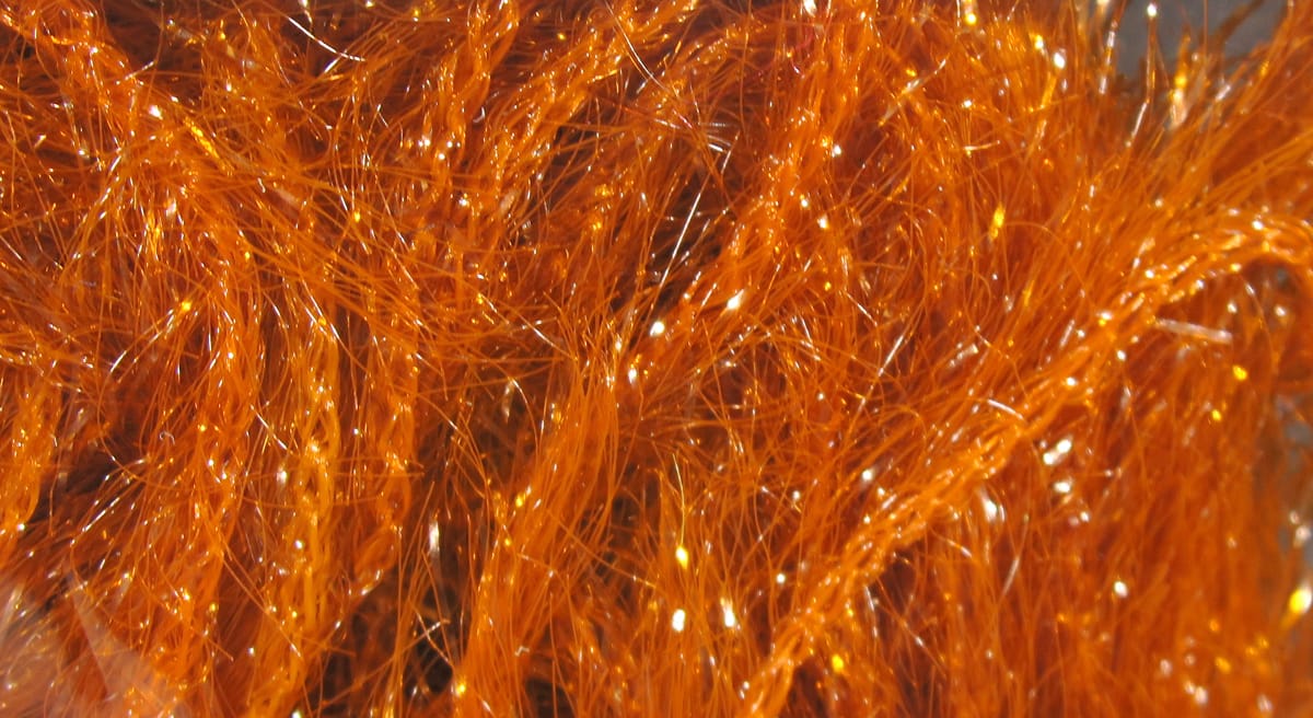 Bright orange Krystal Hackle by Hareline synthetic fly tying flash fibers, glossy shimmering strands with sparkle