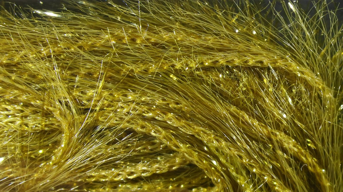 Hareline Krystal Hackle golden synthetic fly tying fibers with sparkling braided strands and fine hairlike fibers