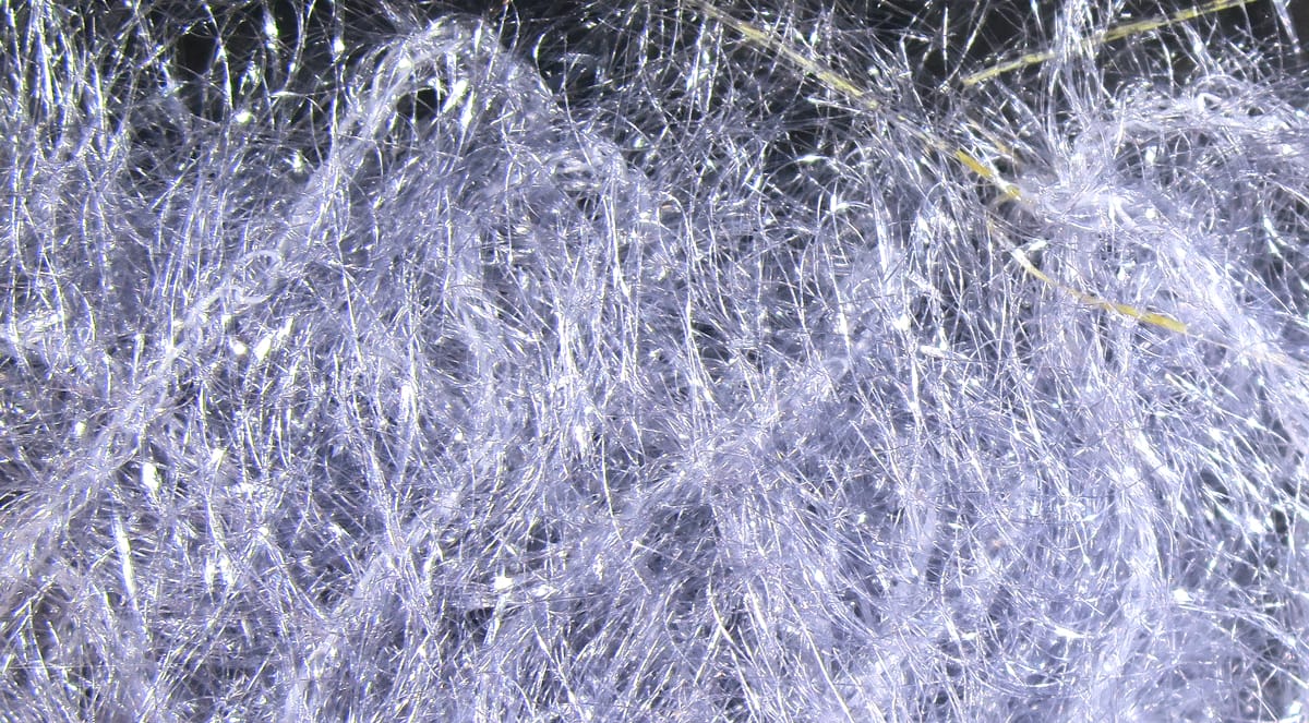 Silvery iridescent synthetic fibers, fluffy hackle strands with sparkle, Hareline Krystal Hackle for fly tying