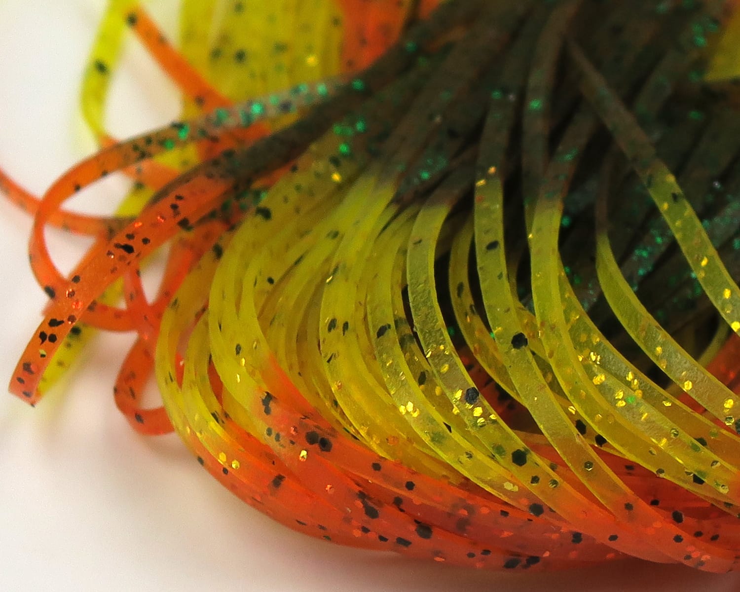 Hareline Magnum predator legs translucent orange and chartreuse rubber fly tying strips with black speckles and gold glitter