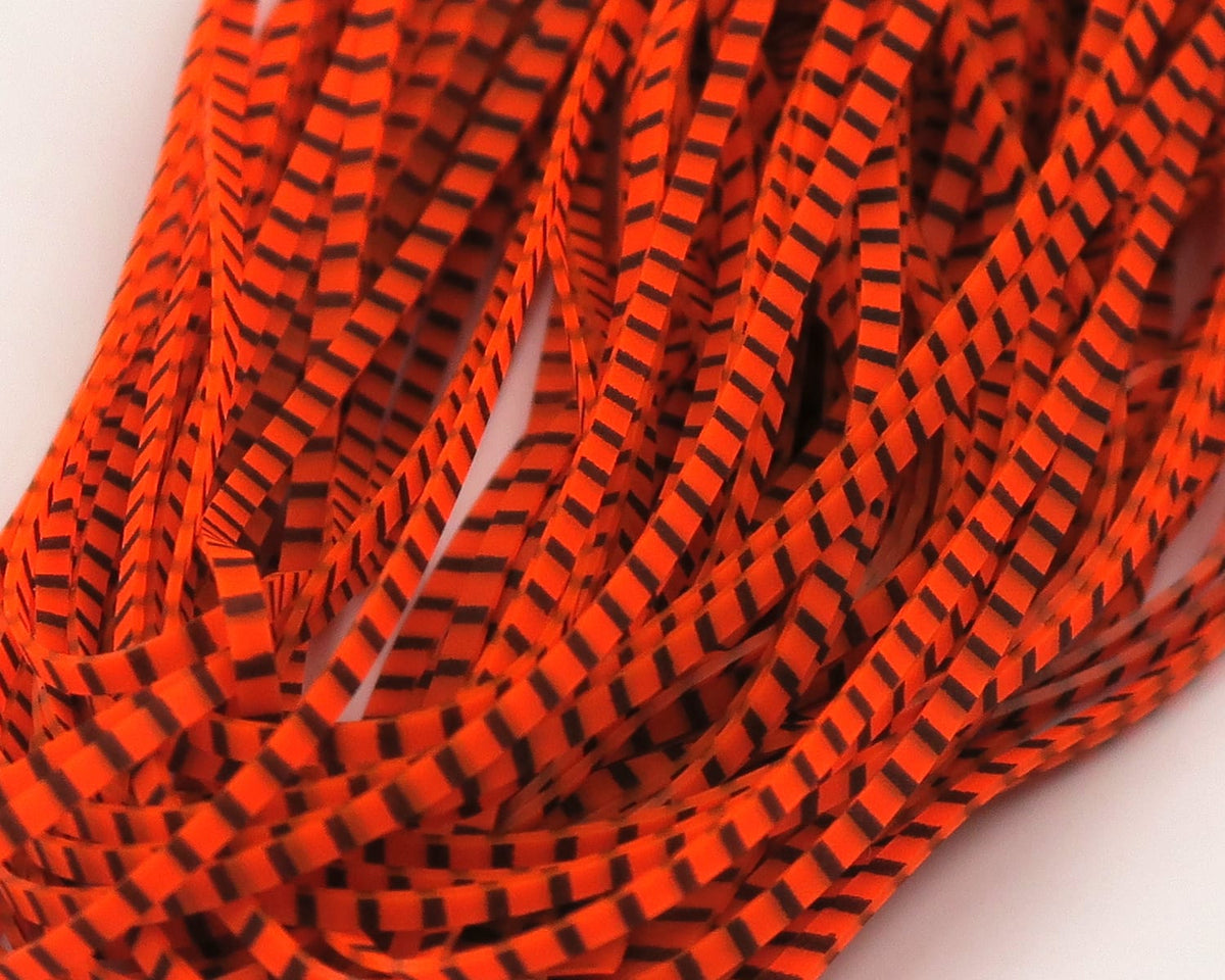 Hareline Magnum predator legs, fluorescent orange synthetic strips with black barred stripes for fly tying