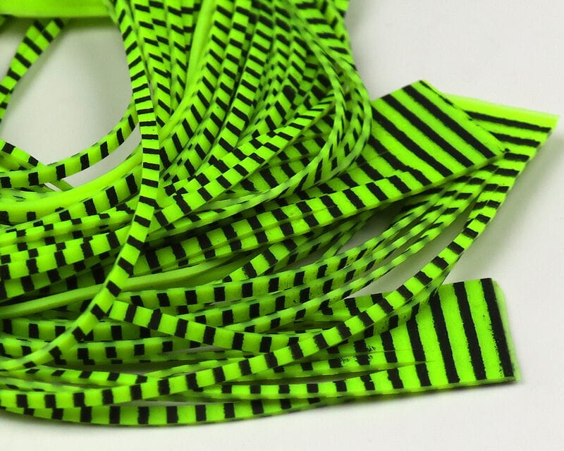 Neon chartreuse rubber predator legs with black bars, striped fly tying material