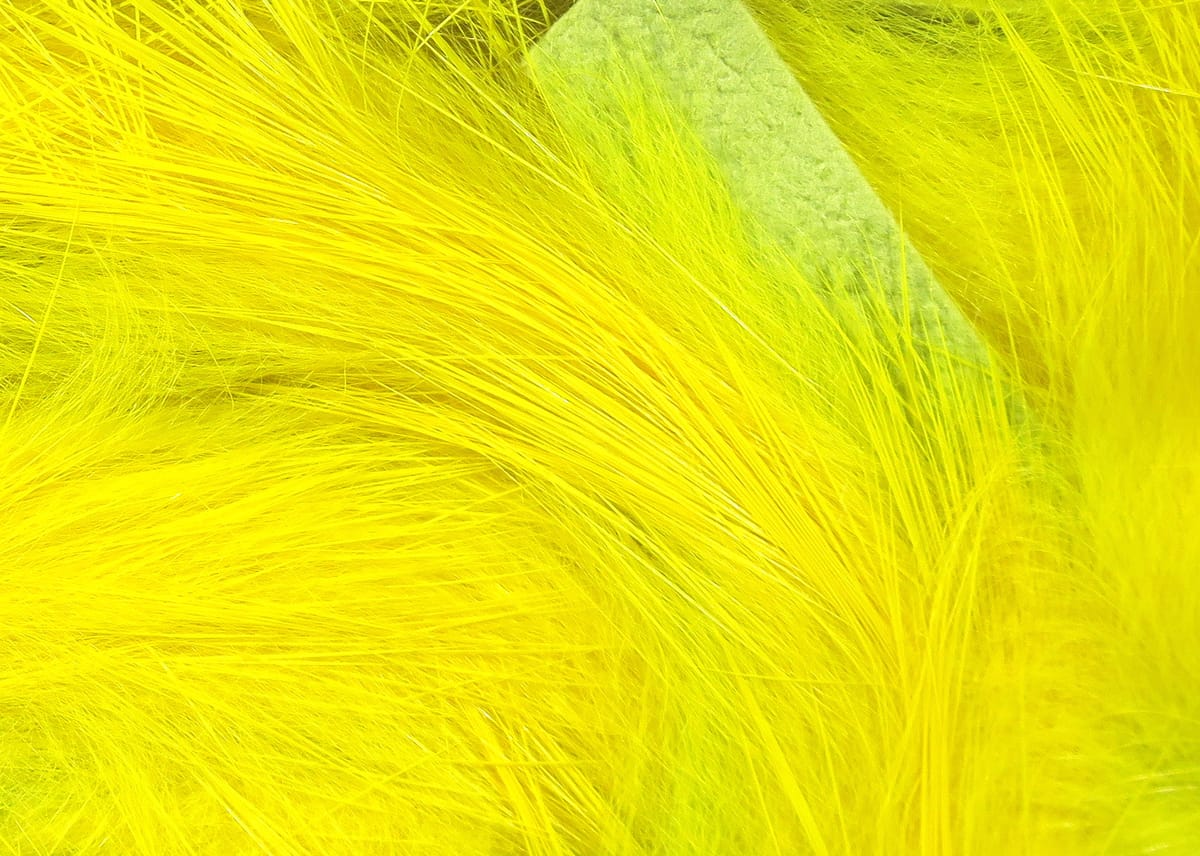 Bright fluorescent yellow Hareline Magnum rabbit fur strips with long silky fibers for fly tying